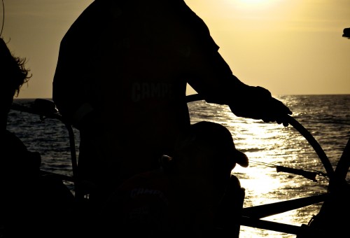 Stu Bannatyne steering at sunset.